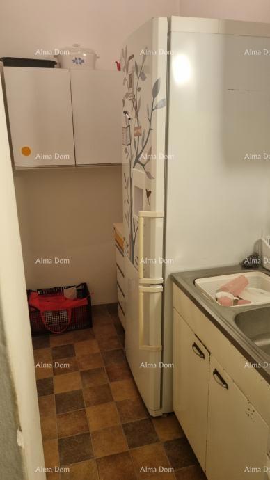 The translation of "Stan u centru Umaga" to Slovenian is "Stanovanje v centru Umaga."