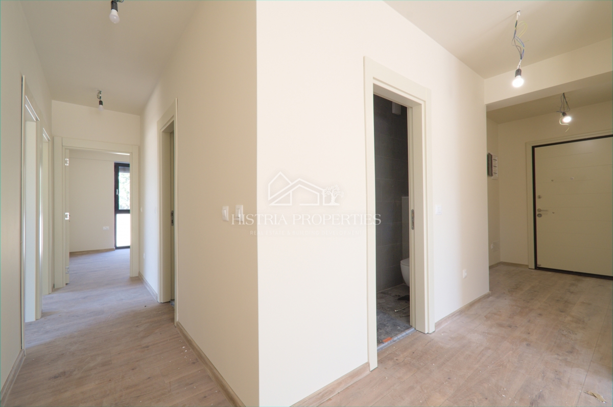 Pritlično stanovanje s skupnim bazenom v luksuzni novogradnji